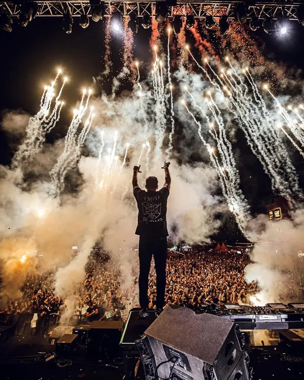 This is the moment we live for. Martin Garrix, one of the world's top DJs, commanding a sea of fans as the fireworks light up the Bengaluru sky. This is the peak energy we deliver, a complete sensory overload that makes for a legendary night.