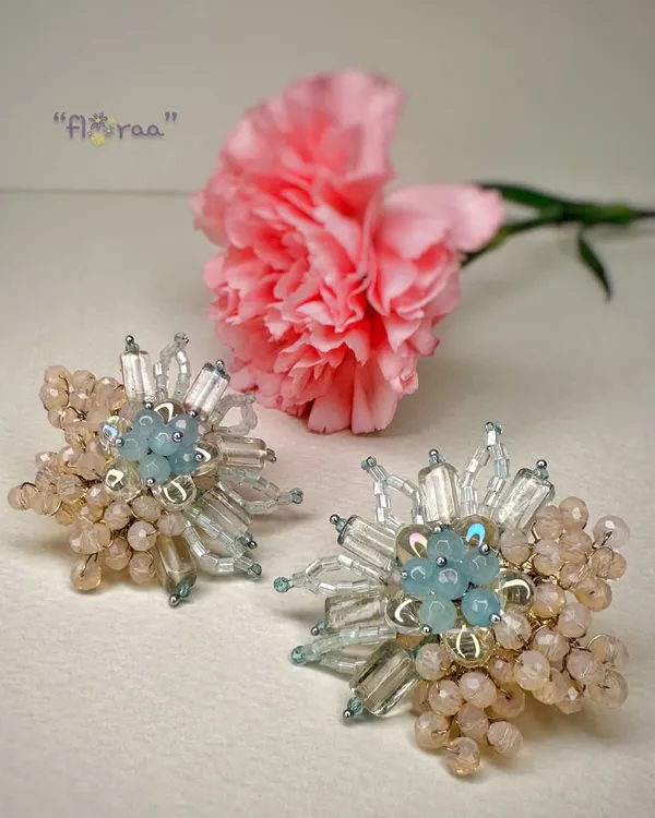 Be a showstopper with these classic handcrafted fashion studs, featuring a beautiful floral design in pastel blue and peach.