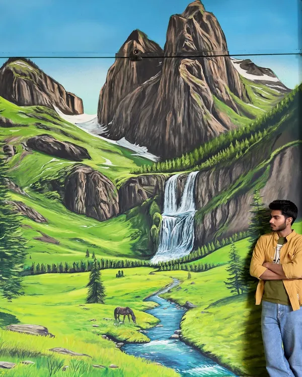 This large-scale mountain landscape mural is designed to bring a sense of peace and escape into a home. I painted this entire valley scene, complete with a waterfall and river, to transform a simple wall into a window to nature.