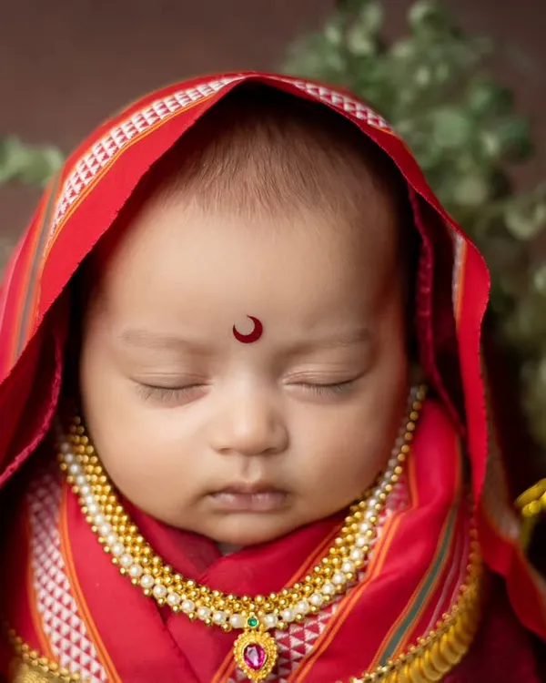 This is one of my favorite themes, celebrating our Maharashtrian heritage. This close-up shot of a baby girl as Rajmata Jijabai captures the serene details, from the traditional bindi and nose ring to the delicate gold jewelry, all while ensuring the baby is sleeping peacefully.