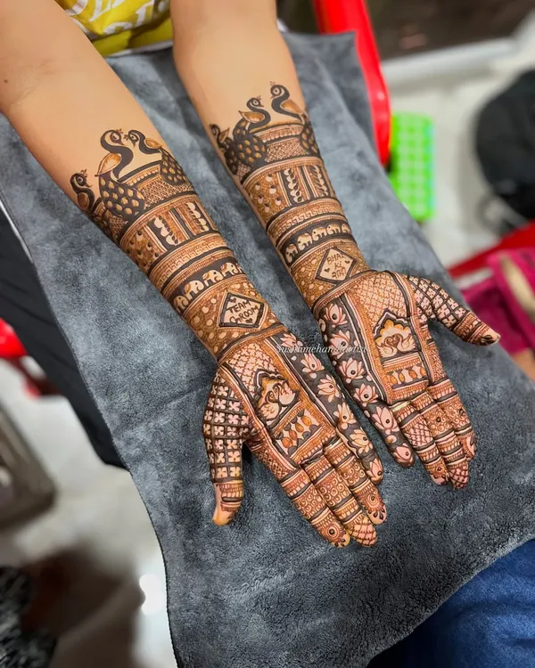 This is the kind of full-arm bridal mehndi that is my passion. I love filling the hands with traditional Indian motifs like peacocks and detailed jaali work, making sure the design is perfect for your big day.