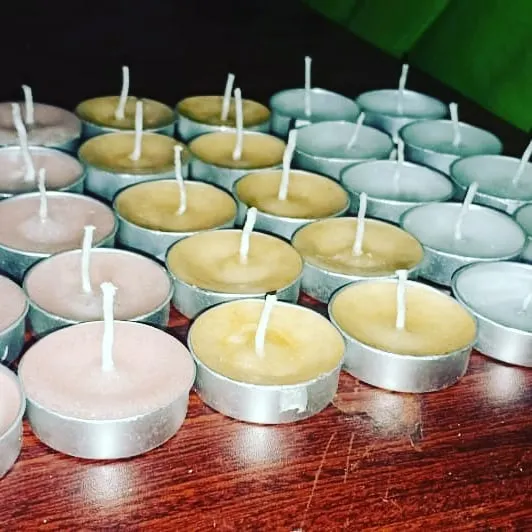 A collection of my handmade tealights in different colors, ready for packaging. You can see the quality wicks I use to ensure a consistent flame.