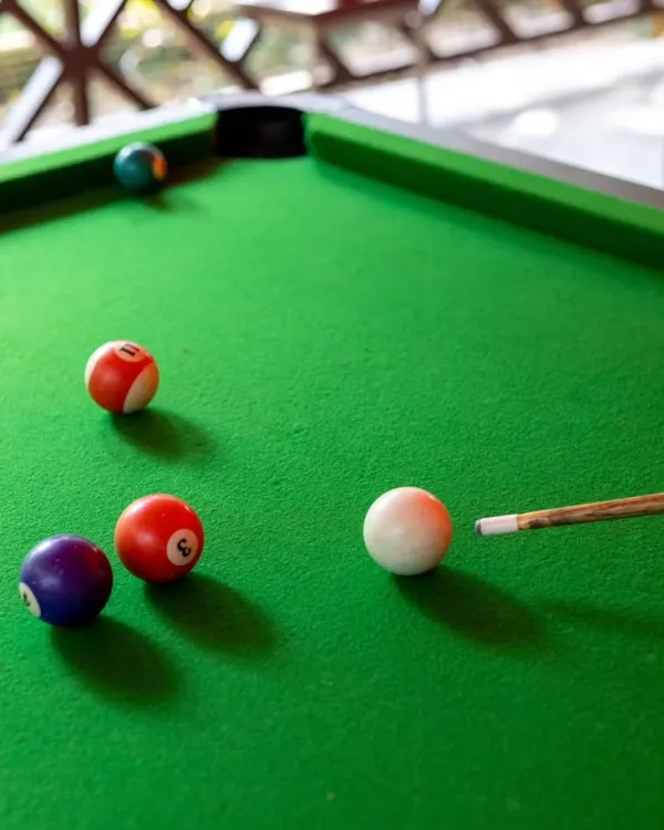 Line up the perfect shot at our pool table. It's a great way to unwind with colleagues and engage in some friendly competition.