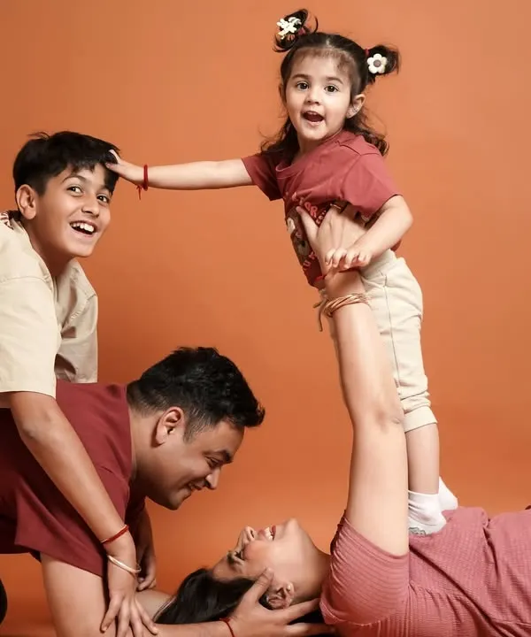 We believe family photos should be full of life and laughter. This playful moment, with everyone piling on, is the kind of happy chaos we love to capture during our family photoshoots.