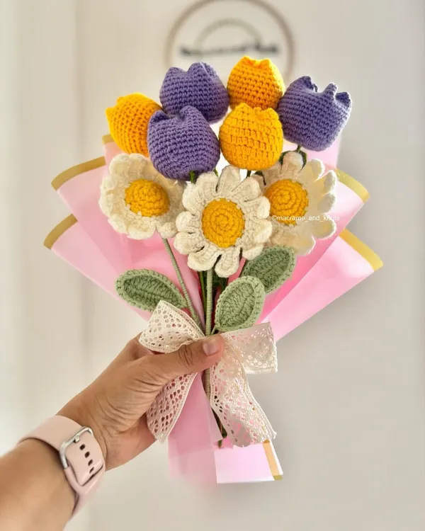 This is another angle of the custom birthday bouquet, showing the arrangement of daisies and tulips. The combination of different flower types and colors makes each handmade bouquet one of a kind.