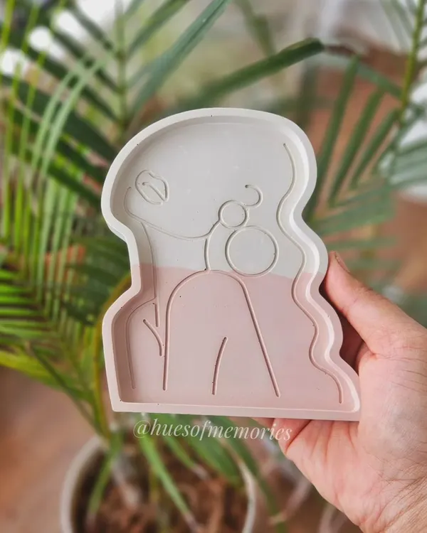 A beautiful shot of my lady trinket tray in a soft pink and white color block. The minimalist line art design makes it a very popular and aesthetic piece for any vanity or desk.