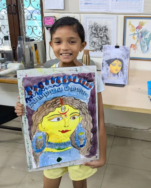 The pure joy of a finished masterpiece! Here is one of our youngest students, Naomika, proudly showing off her vibrant Durga Ma watercolor painting. We love seeing these happy smiles at the end of a class.