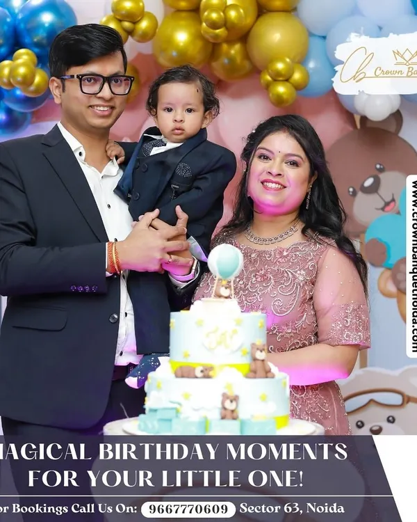We create magical birthday moments for your little one. This family portrait captures the happiness of a first birthday, complete with a custom-themed cake and a backdrop of festive blue and gold balloons.