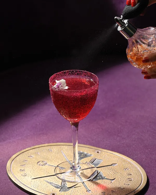 This is the Ruby Myers, a tribute to a silent film star with all the charm and drama you'd expect. I add the final touch with a spritz of aromatic essence, making it a full sensory experience.