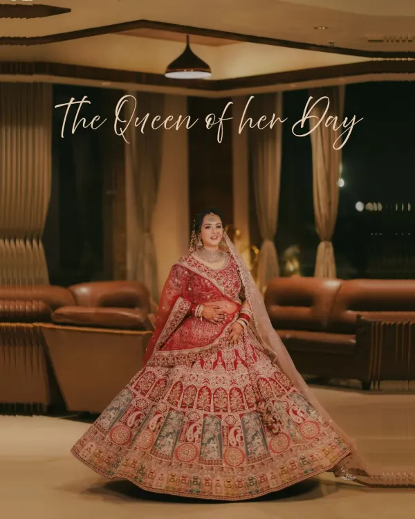 A breathtaking full-length portrait of the bride, showcasing her magnificent lehenga spread out like a queen's gown. A true statement shot.