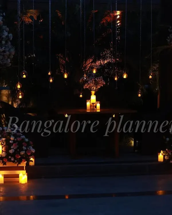 A breathtaking outdoor dinner setting designed for pure romance. I used dozens of hanging lights and candles to create a magical, intimate atmosphere around a private table for two.
