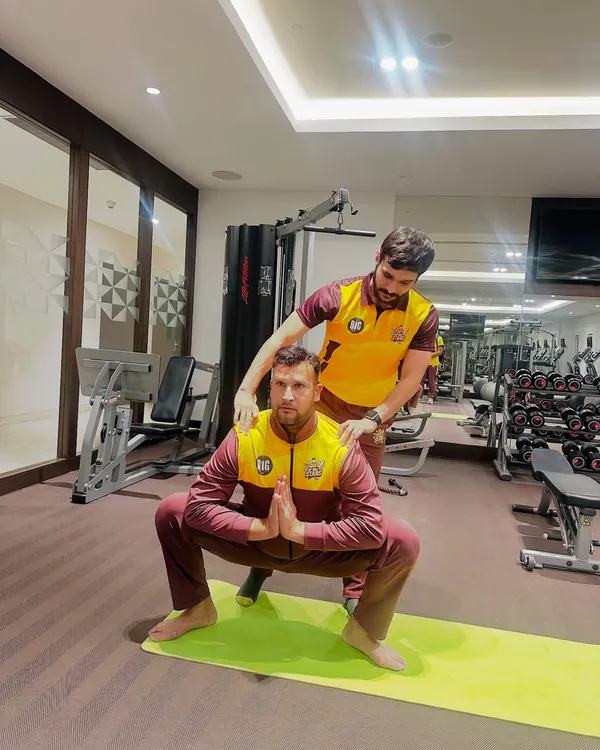 I provide hands-on adjustments to ensure athletes achieve correct posture, like in this Malasana (Garland Pose) with cricketer Ishwar Pandey. This focus on form is crucial for building foundational strength and preventing injuries.