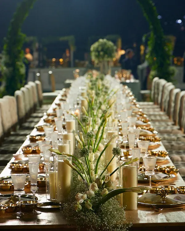 We believe an unforgettable meal begins with an unforgettable setting. This is a glimpse into how we transform spaces into opulent dining experiences, where every guest is seated for an evening of culinary delight under a canopy of warm lights.