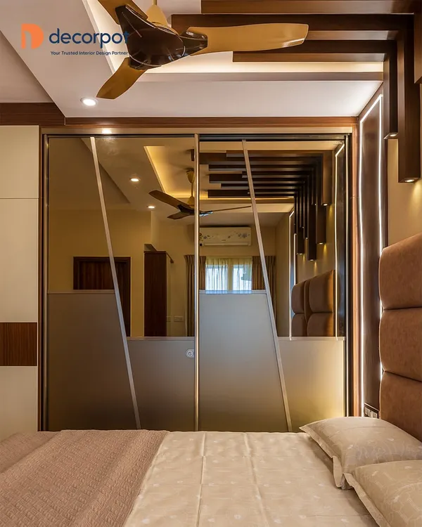 This lacquered glass sliding wardrobe combines frosted and reflective surfaces to create a sense of depth and elegance in the master bedroom. The design not only saves space but also adds a layer of modern sophistication, reflecting the room's ambient light beautifully.