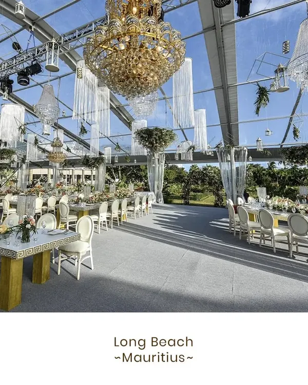 A spectacular wedding reception we catered at Long Beach, Mauritius. The transparent marquee, adorned with magnificent chandeliers, allowed guests to dine under the sky, blending opulent decor with the beauty of a tropical paradise.