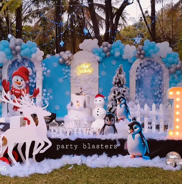 A complete winter wonderland theme for a 10th birthday. We created this immersive outdoor setup with custom backdrops, life-sized props like a polar bear, reindeer, and penguins, and marquee lighting for the age. The artificial snow and cool blue lighting complete the chilly, magical atmosphere.