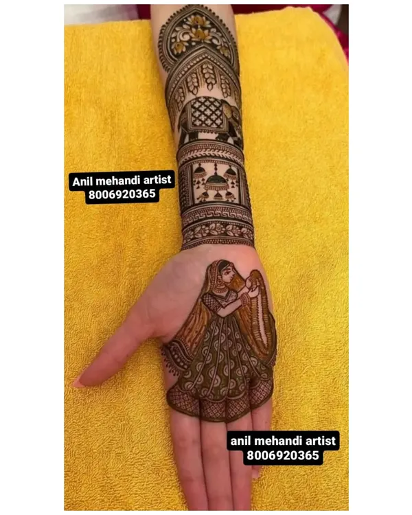 This custom design features a bride figure on the palm. Above her, the arm is decorated with an elephant motif and a depiction of a palace, telling a royal wedding story.