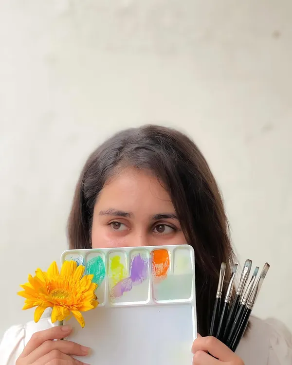 A photo of me with my art supplies, reflecting on my creative process.