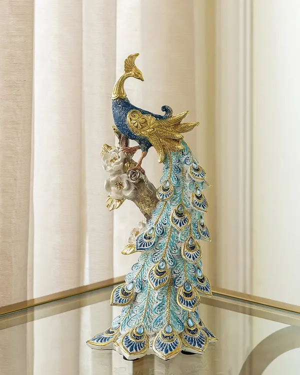This majestic peacock showpiece is a customer favorite. The intricate detailing on its cascading tail feathers, finished in beautiful shades of blue and gold, makes it a stunning symbol of grace and beauty.