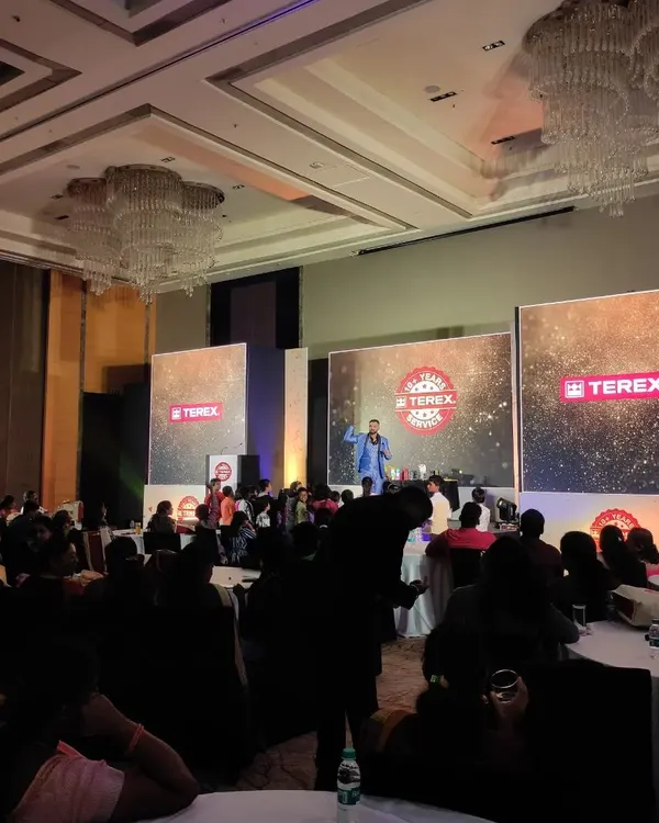 On stage for Terex Corporation at the Marriott, Whitefield. The grand ballroom setting was perfect for a large-scale corporate show with multiple LED screens and a full audience.