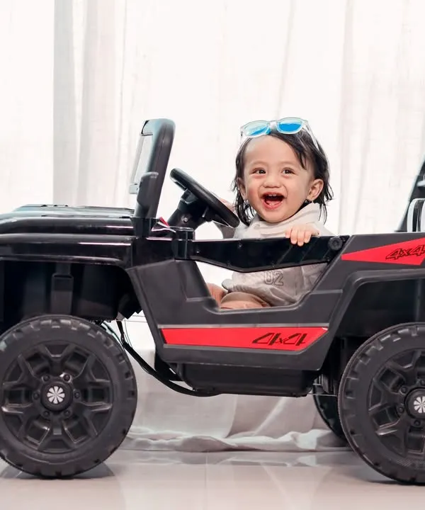 License to be cute. This little driver is having a blast in our toy jeep, a prop that always brings out the biggest smiles.
