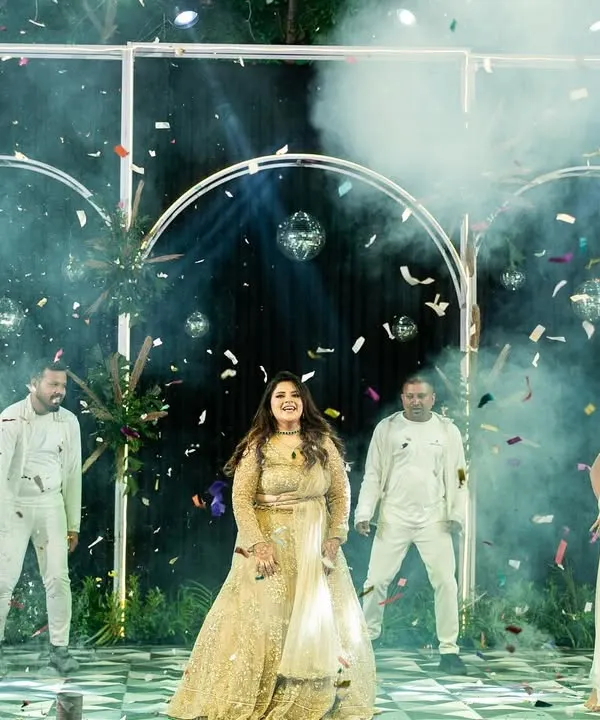 A bride's solo performance is all about joy and celebration. Here, Mahek is surrounded by backup dancers and confetti, creating a grand, cinematic moment during her sangeet.