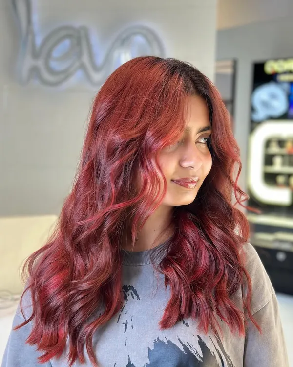 Red vibes only. This fiery red hair color is bold, vibrant, and full of passion. A true statement look.