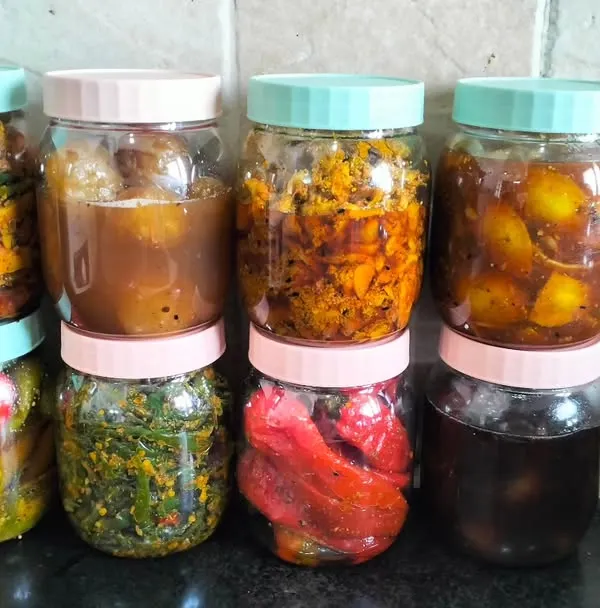 A selection of my pickles, all bottled up and ready to be enjoyed. This lineup includes stuffed red chilli, mixed vegetable, and sweet lemon pickle.