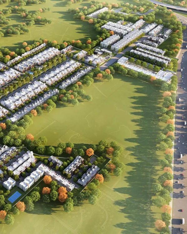 An expansive aerial view of the AIPL Dream City NXT master plan in Amritsar. The layout is intentionally porous, with large green fields and sports areas acting as community anchors and providing ample open space for residents.