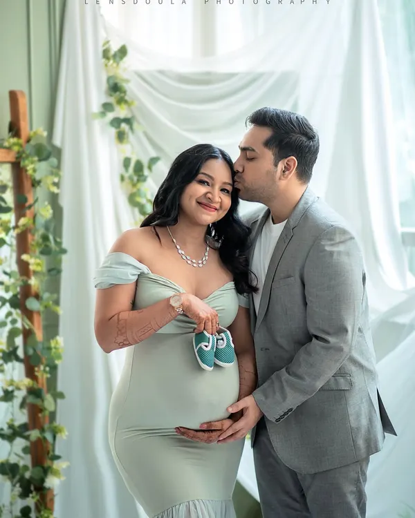 A sweet and symbolic portrait, with the parents-to-be holding up a tiny pair of shoes. This is a beautiful way to announce the coming arrival of their little one.