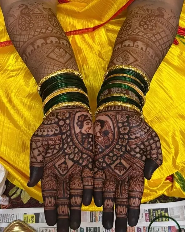 A close-up of a custom couple portrait, beautifully framed on the palm. The dark, rich stain you see is the result of my 100% natural henna paste, ensuring a safe and stunning look for your wedding.