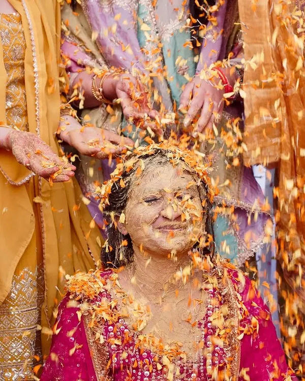 A moment of pure bliss as the bride is showered with marigold petals during her haldi. I focus on capturing these beautiful, candid rituals that are full of emotion.