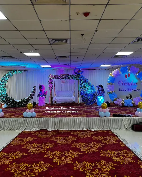 This is one of my grand stage decorations for a baby shower in a banquet hall. I combined several popular elements here: a traditional Sankheda jhula (swing), a beautiful floral crescent moon for photos, and a large balloon ring backdrop with the baby's name for a personal touch.