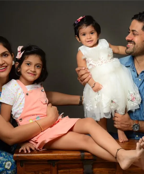 A happy family of four during their studio session. I aim to capture both posed and candid moments that show the love and connection between parents and children.
