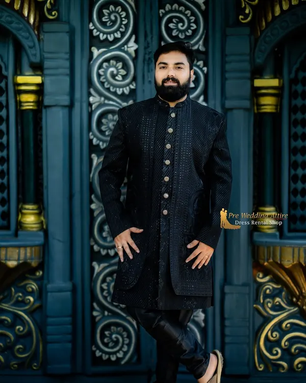 This is a closer look at my black textured sherwani. The intricate, self-color pattern and premium buttons give it a sophisticated and modern edge, perfect for pairing with a vibrant lehenga.