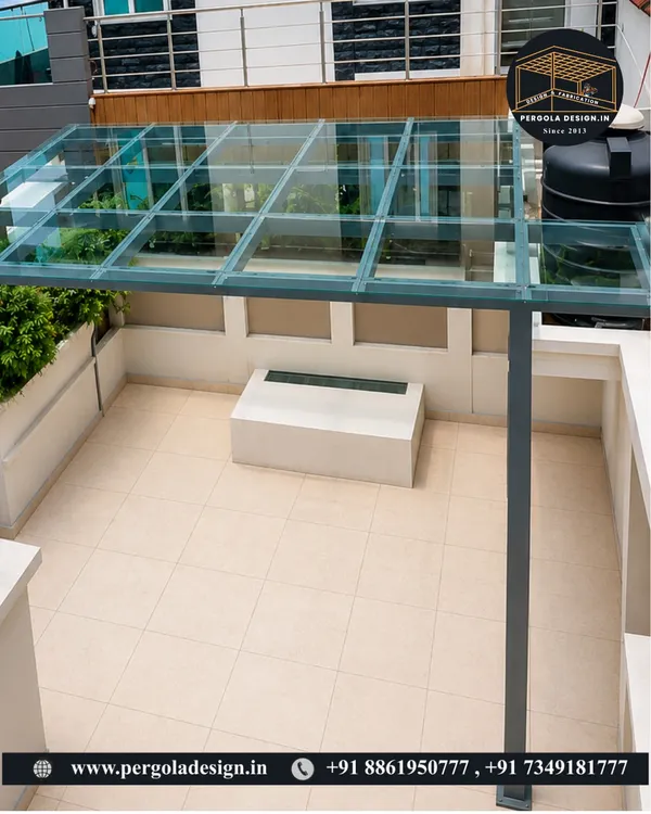 This high-angle shot shows the clean, minimalist aesthetic of our finished glass roof pergola. The structure provides complete rain protection for the terrace below without sacrificing the open, airy feeling of the space.