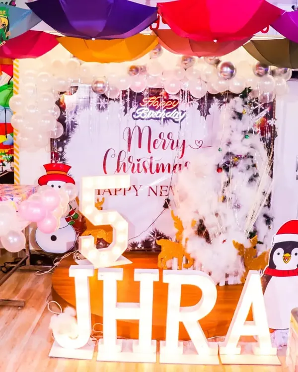 This was the setup for Jhra's magical 5th birthday, which had a full Christmas theme. We arranged the marquee lights, winter wonderland backdrop, and balloon arrangements to create a festive and personalized party atmosphere.