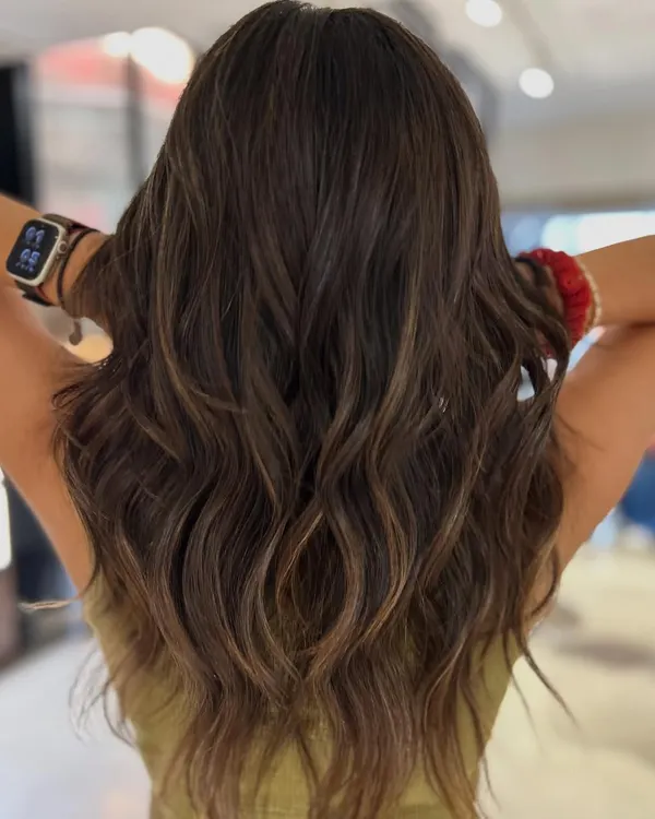 This brunette balayage adds incredible movement and the illusion of volume. I used a two-tone beige blend to create soft, natural-looking dimension that complements her base color perfectly.