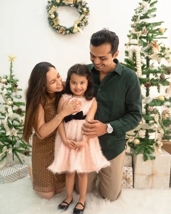 A beautiful family portrait from my Christmas mini-sessions. The festive trees and soft lighting create a magical holiday atmosphere for this sweet photo.
