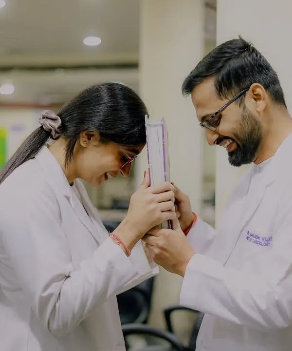 Back to the classroom where their story began. This playful shot with a medical instrument is a perfect example of a themed shoot that is both fun and deeply personal to the couple's journey as doctors.