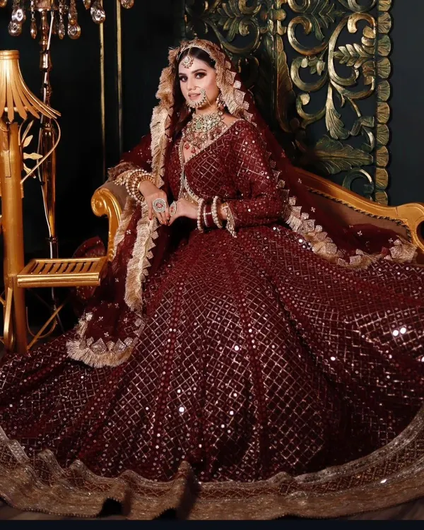A breathtaking maroon sequin lehenga for the bride who wants a deep, royal color palette. The all-over sparkle and grand design make it perfect for a nighttime wedding ceremony.
