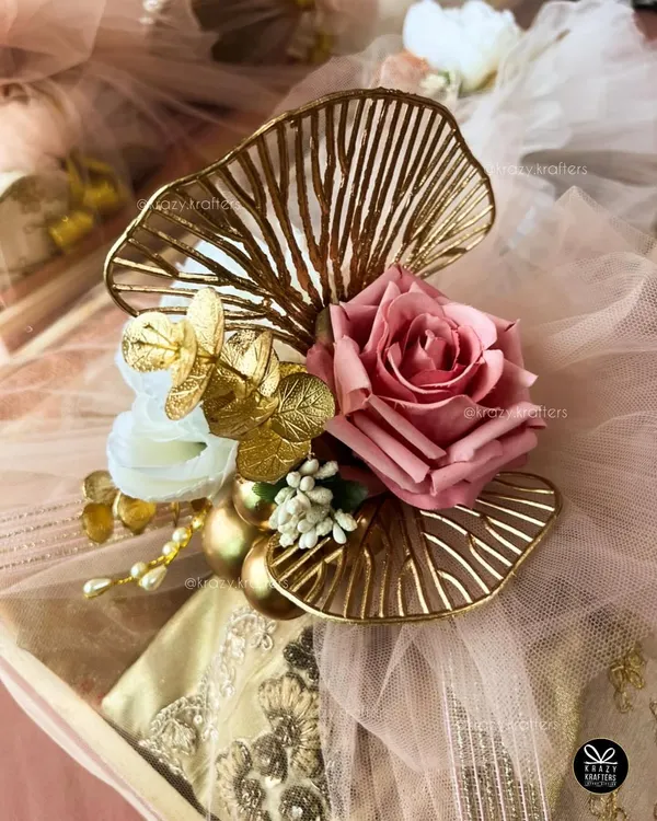 A close-up of the intricate details on my trousseau packaging. I use elements like these golden ginkgo leaf accents and artificial roses to create a rich, luxurious look.