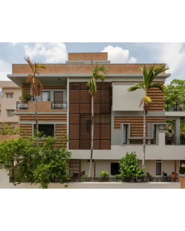 The facade of the Ananda residence in Hyderabad, where we renovated an existing structure to minimize waste. The new walls are built with compressed stabilised earth blocks (CSEB) in alternating courses, a technique that creates a self-shading, thermally efficient surface.