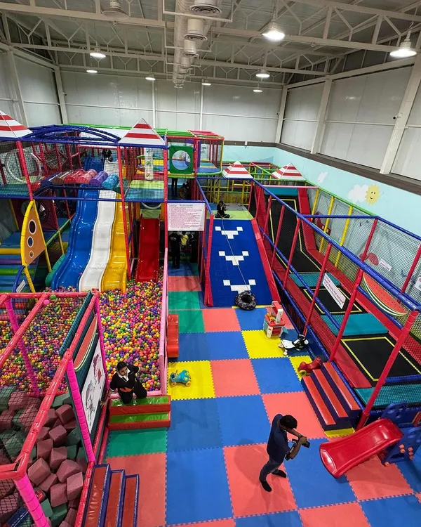 Welcome to Kydoland. This is the heart of our play center, a sprawling, multi-level structure designed for endless exploration, from the colorful ball pit to the exciting slides and trampolines.