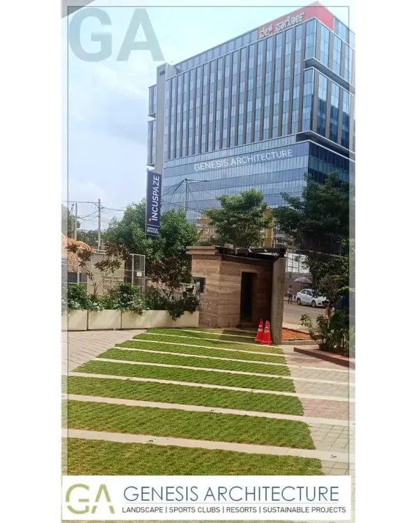 The landscape design for this corporate office in Bangalore integrates green spaces directly into the commercial environment. The use of grass pavers and native plants helps manage stormwater and creates a more pleasant, natural setting for employees.