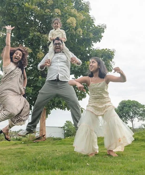 This is what pure, chaotic joy looks like. We believe family photos should be about capturing your unique energy, and outdoor sessions in a place like this Bangalore field give us the space to let everyone's true personality shine.