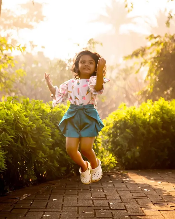 A birthday jump for joy! I love encouraging kids to move and play during our outdoor sessions. This spontaneous moment of excitement perfectly captures the energy of a happy three-year-old.