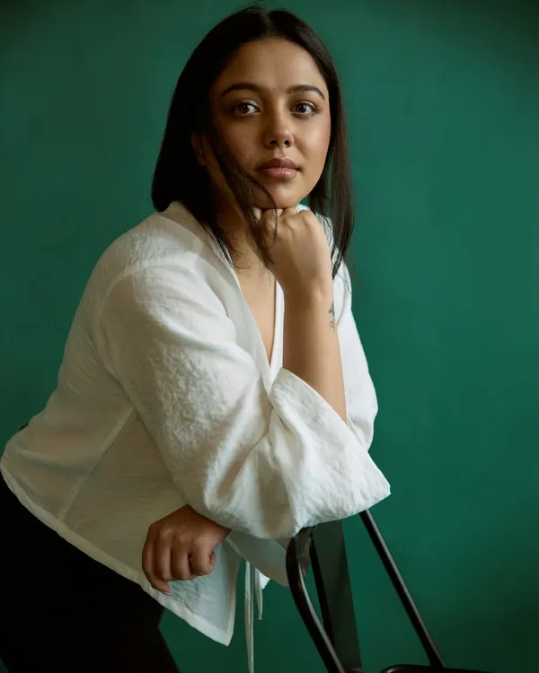 A simple portrait against a rich green backdrop. The color provides a beautiful contrast while the soft light and relaxed pose create a feeling of calm and approachability.