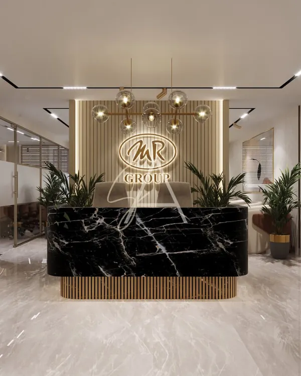 The reception desk for the MR Group, featuring a bold black marble front and fluted wood base. We used warm backlighting and elegant globe pendant lights to create a powerful and sophisticated entry point for this corporate office in Defence Colony.