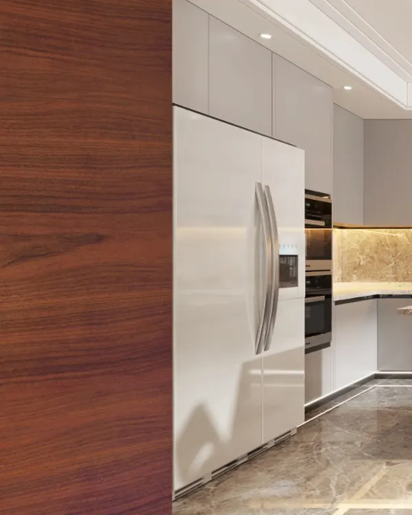 A close-up of a modern kitchen, showing the seamless integration of the refrigerator with high-gloss white cabinets and a rich American walnut wood panel.